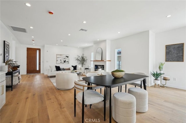 5449 S Victoria Ave, Los Angeles, CA 90043 - dining area with visible vents, recessed lighting, light wood-style floors, and a glass covered fireplace