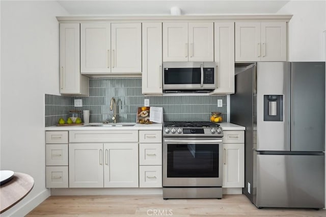 5449 S Victoria Ave, Los Angeles, CA 90043 - kitchen with stainless steel appliances, decorative backsplash, light countertops, and a sink