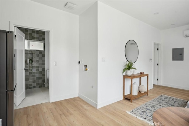 5449 S Victoria Ave, Los Angeles, CA 90043 - hall featuring light wood finished floors, a wall unit AC, electric panel, and baseboards