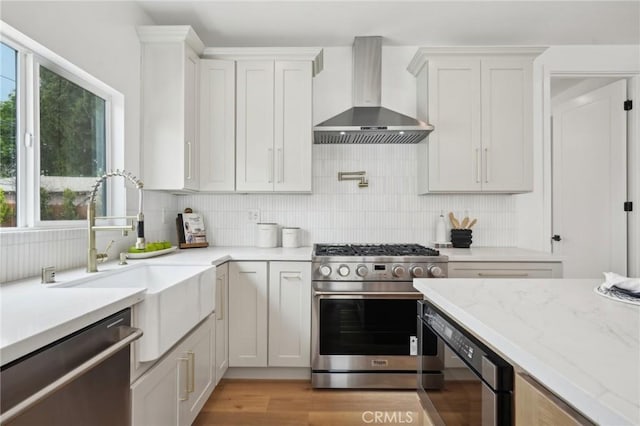 5449 S Victoria Ave, Los Angeles, CA 90043 - kitchen with wall chimney exhaust hood, a sink, backsplash, and appliances with stainless steel finishes