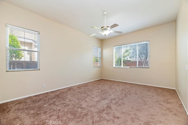 empty room featuring carpet flooring, ceiling fan, and baseboards