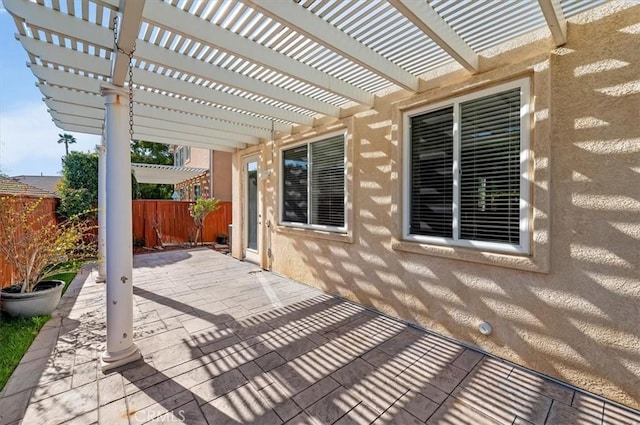 view of patio / terrace featuring fence and a pergola