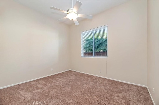 empty room featuring a ceiling fan, carpet flooring, and baseboards