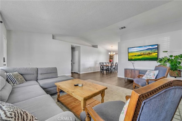37025 96th St E, Littlerock, CA 93543 - living room with a chandelier, wood finished floors, visible vents, a textured ceiling, and lofted ceiling