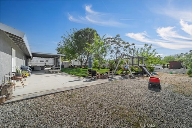 37025 96th St E, Littlerock, CA 93543 - exterior space with fence, a fire pit, a patio area, and a playground