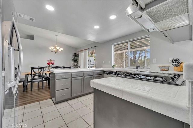 37025 96th St E, Littlerock, CA 93543 - kitchen with gray cabinetry, recessed lighting, a peninsula, and wall chimney exhaust hood