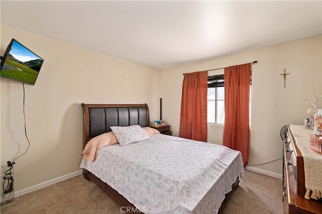 carpeted bedroom with baseboards