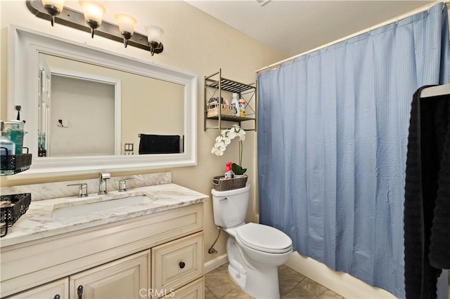bathroom with tile patterned floors, curtained shower, toilet, and vanity
