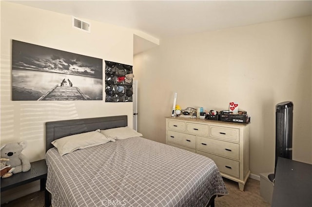 carpeted bedroom featuring visible vents