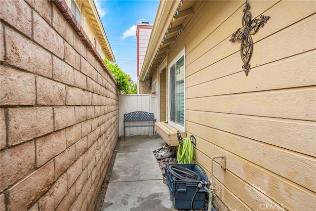 view of home's exterior featuring fence and a patio