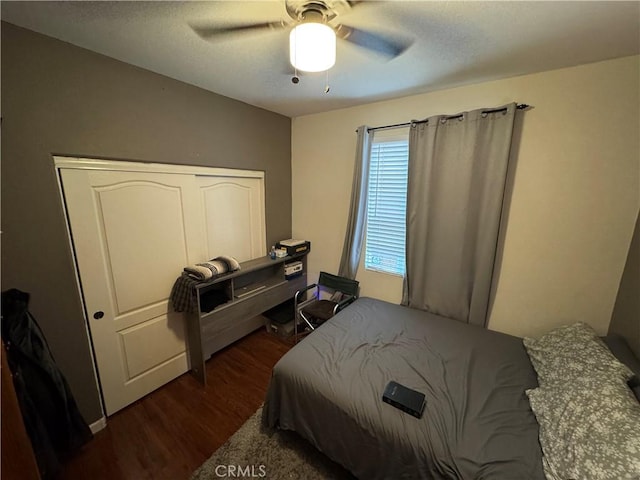 bedroom with ceiling fan and dark wood-type flooring