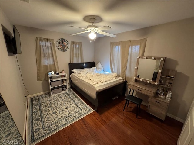 bedroom featuring a ceiling fan, wood finished floors, and baseboards