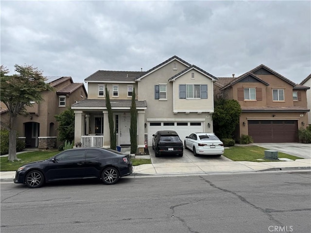 view of front of property featuring a garage, a porch, stucco siding, and concrete driveway