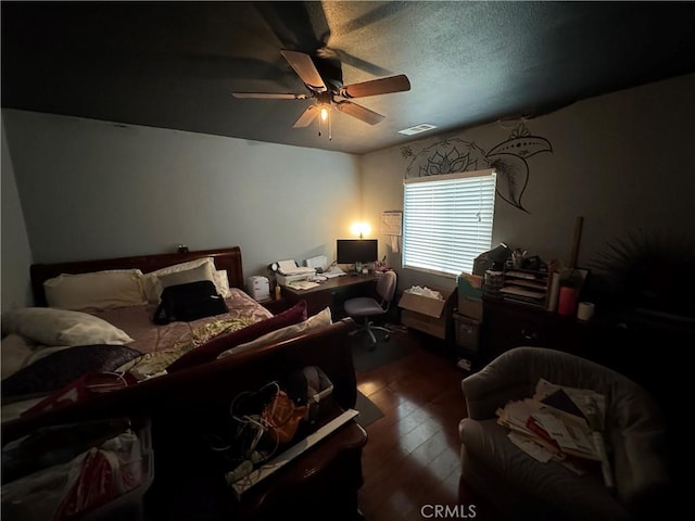 bedroom with visible vents, ceiling fan, and wood-type flooring