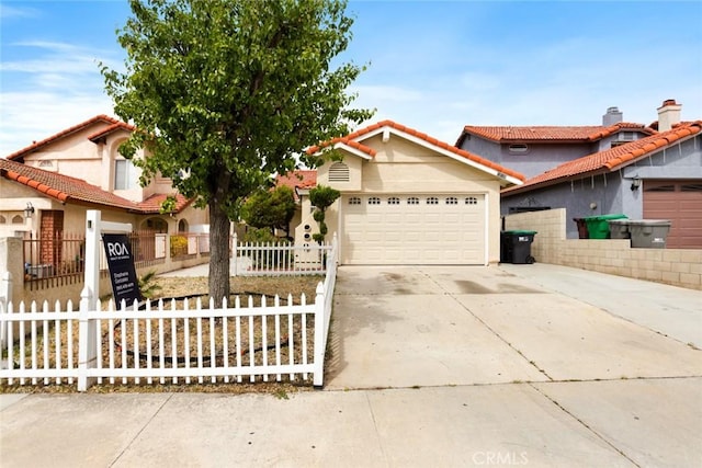 13139 Kiowa Dr, Moreno Valley, CA 92553 - view of front of house featuring an attached garage, concrete driveway, stucco siding, and a fenced front yard