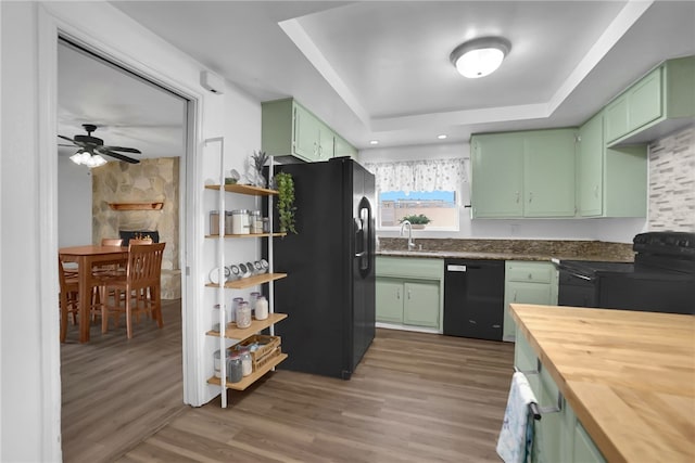 649 Sycamore Ave, Claremont, CA 91711 - kitchen with green cabinets, black appliances, a sink, a raised ceiling, and wooden counters