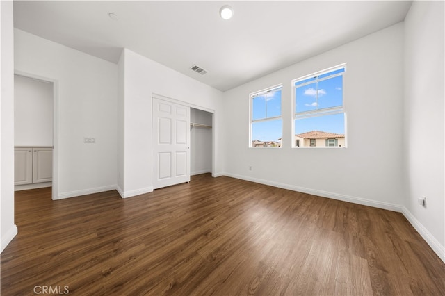 16005 Blueberry Ave, Chino, CA 91708 - unfurnished bedroom featuring a closet, visible vents, baseboards, and dark wood finished floors