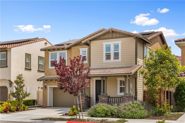 16005 Blueberry Ave, Chino, CA 91708 - view of front of house featuring driveway, a tile roof, solar panels, an attached garage, and a porch