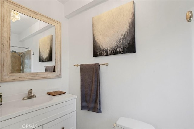 full bath with vanity, a shower, and toilet