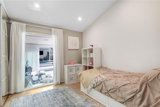 tiled bedroom featuring vaulted ceiling and access to exterior