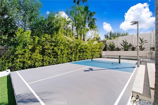 view of tennis court with fence and basketball court