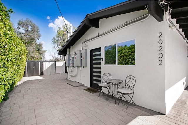 exterior space featuring stucco siding and a patio area