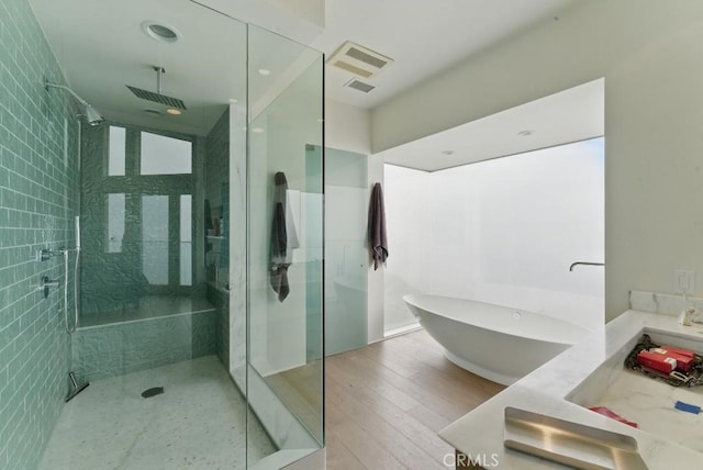 bathroom featuring a freestanding tub, visible vents, vanity, and a stall shower