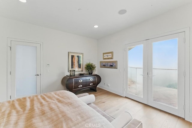 bedroom featuring wood finished floors, french doors, recessed lighting, and access to outside