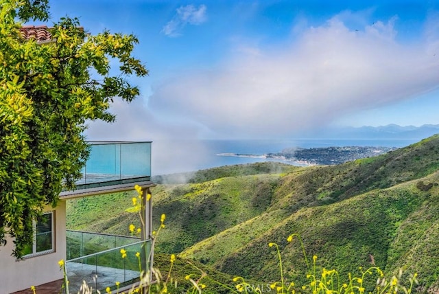 exterior space with a water and mountain view