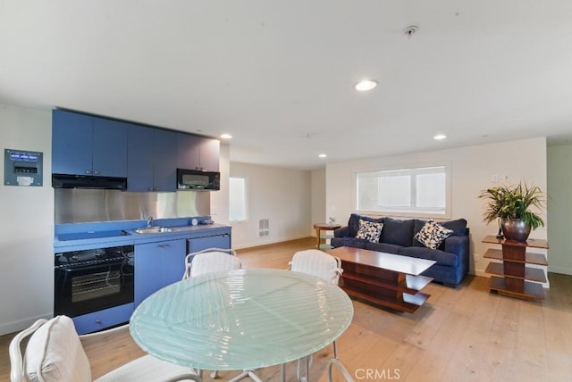 dining room with light wood-type flooring, recessed lighting, and baseboards