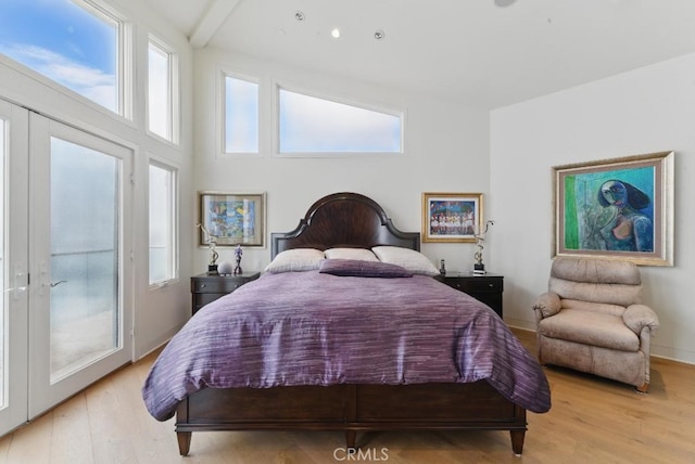 bedroom with light wood finished floors and baseboards