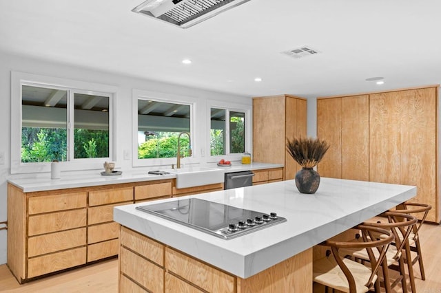 14980 Via De La Valle, Del Mar, CA 92014 - kitchen featuring black electric cooktop, a sink, light wood-style flooring, dishwasher, and a wealth of natural light