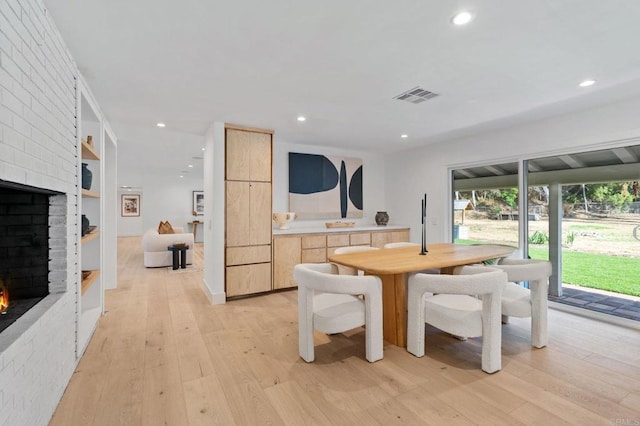 14980 Via De La Valle, Del Mar, CA 92014 - dining space with visible vents, built in features, a fireplace, recessed lighting, and light wood-style flooring