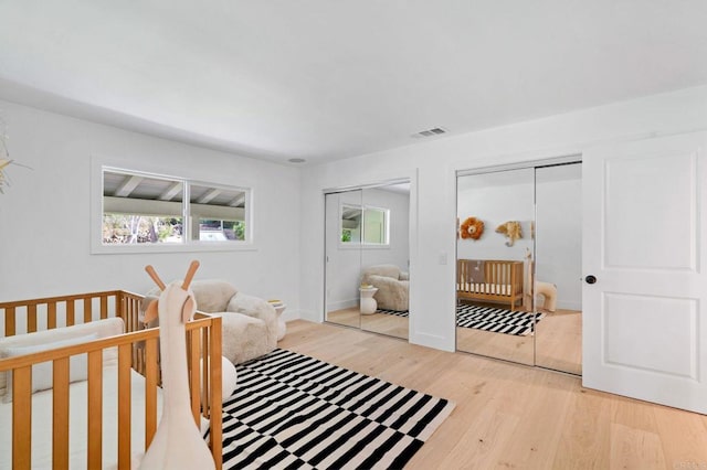 14980 Via De La Valle, Del Mar, CA 92014 - bedroom with multiple closets, baseboards, wood finished floors, and visible vents