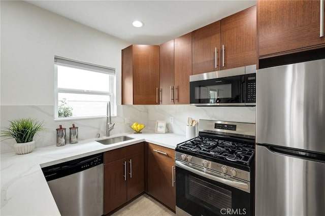 724 San Miguel Ave, Venice, CA 90291 - kitchen with decorative backsplash, a sink, stainless steel appliances, light stone countertops, and recessed lighting