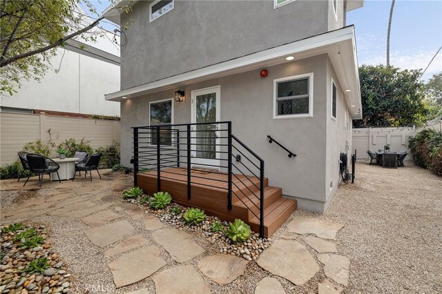 724 San Miguel Ave, Venice, CA 90291 - view of exterior entry featuring a patio, stucco siding, and fence