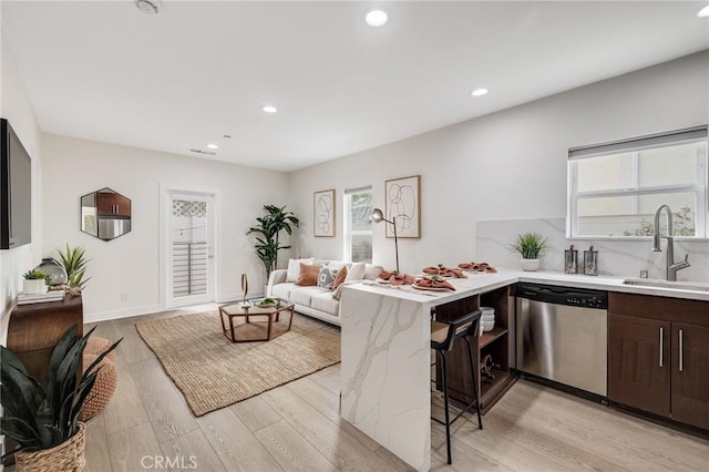 724 San Miguel Ave, Venice, CA 90291 - kitchen featuring stainless steel dishwasher, light wood-style flooring, dark brown cabinets, a sink, and a peninsula