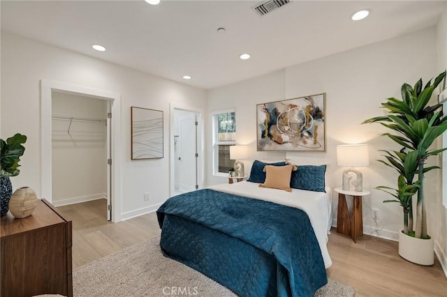 724 San Miguel Ave, Venice, CA 90291 - bedroom with a walk in closet, recessed lighting, visible vents, and wood finished floors