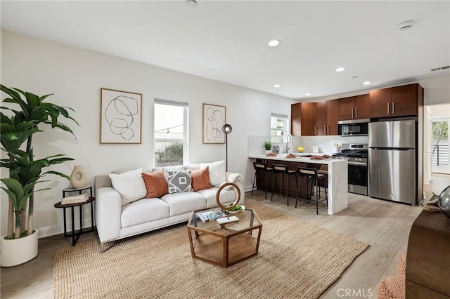 724 San Miguel Ave, Venice, CA 90291 - living room featuring recessed lighting, a wealth of natural light, and light wood-type flooring