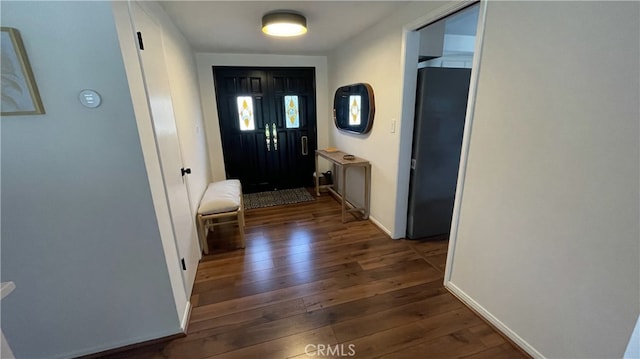 interior space with baseboards and hardwood / wood-style floors