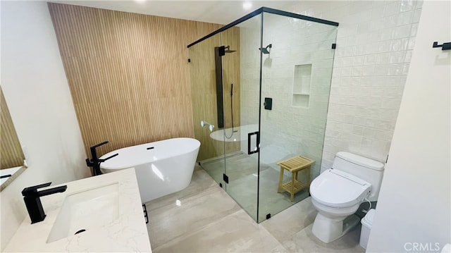full bathroom with a freestanding bath, vanity, toilet, marble finish floor, and a shower stall
