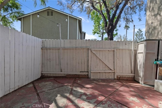 8482 Benjamin Dr Unit 10, Huntington Beach, CA 92647 - view of patio with a gate and fence