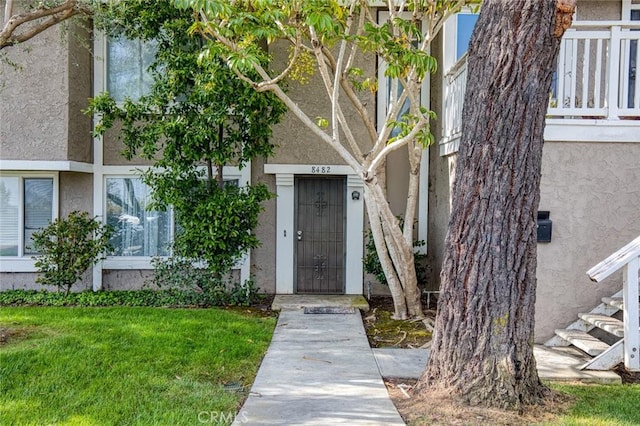 8482 Benjamin Dr Unit 10, Huntington Beach, CA 92647 - property entrance featuring a lawn and stucco siding