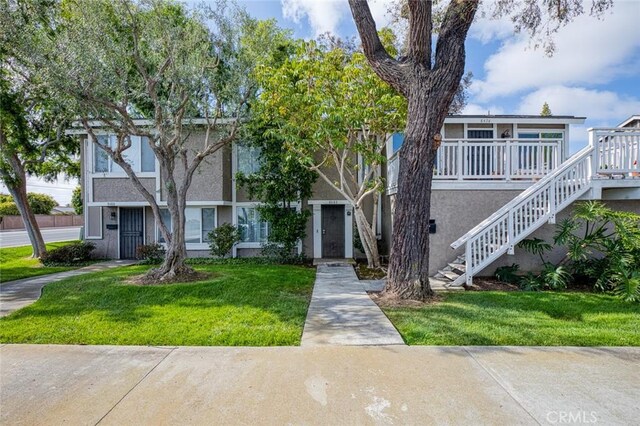 8482 Benjamin Dr Unit 10, Huntington Beach, CA 92647 - multi unit property with stairway, a front lawn, and stucco siding