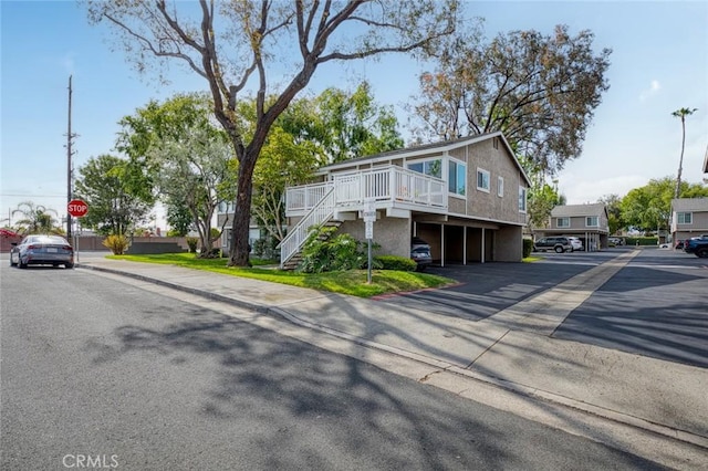 8482 Benjamin Dr Unit 10, Huntington Beach, CA 92647 - view of front of home with parking, stairway, and a deck