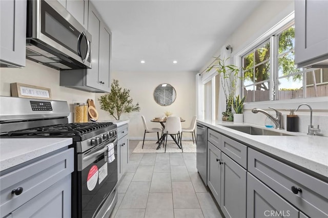 8482 Benjamin Dr Unit 10, Huntington Beach, CA 92647 - kitchen with a sink, appliances with stainless steel finishes, light tile patterned floors, and gray cabinetry