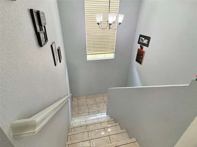 39557 Warbler Dr, Temecula, CA 92591 - stairs with a chandelier and marble look tiles