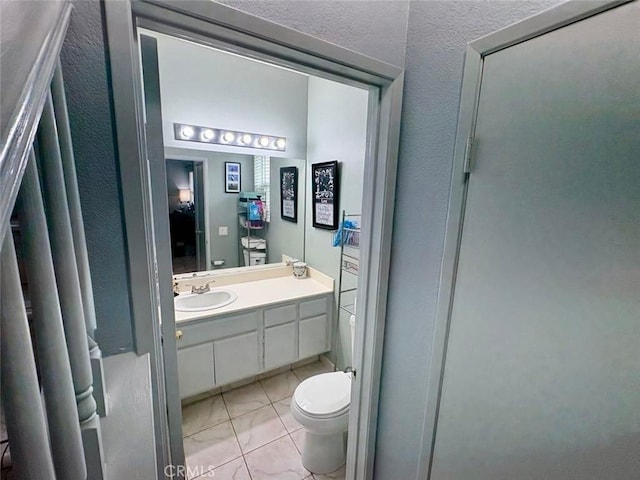 39557 Warbler Dr, Temecula, CA 92591 - bathroom featuring toilet, tile patterned floors, vanity, and a textured wall
