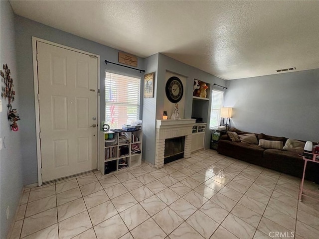 39557 Warbler Dr, Temecula, CA 92591 - living area with a textured ceiling, healthy amount of natural light, and a fireplace