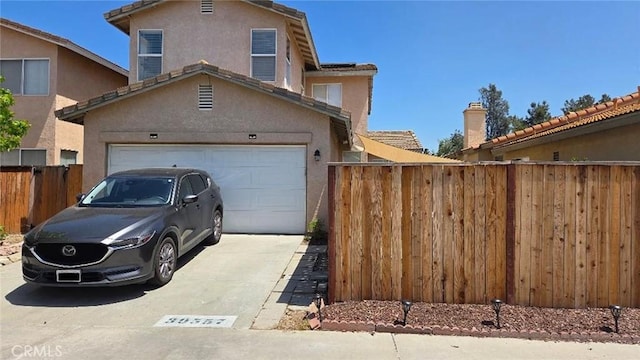 39557 Warbler Dr, Temecula, CA 92591 - view of front of house featuring concrete driveway, fence, stucco siding, and an attached garage